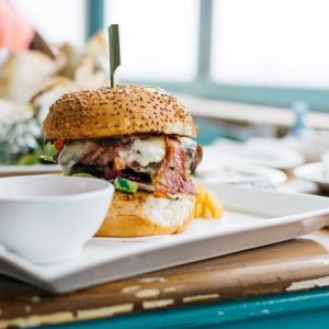 juicy-burger-in-a-vibrant-colorful-interior-FX2VZ6W.jpg